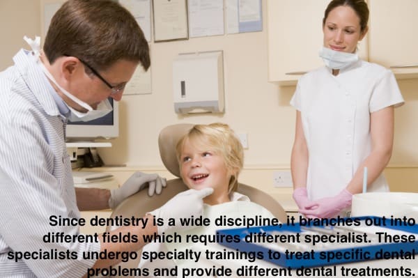 child in dentist's chair smiling and dentist who is inspecting his smile.