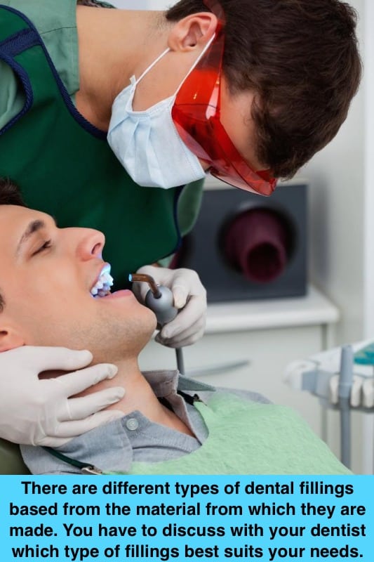 dentist with protective goggles operating on patient with ultraviolet light,