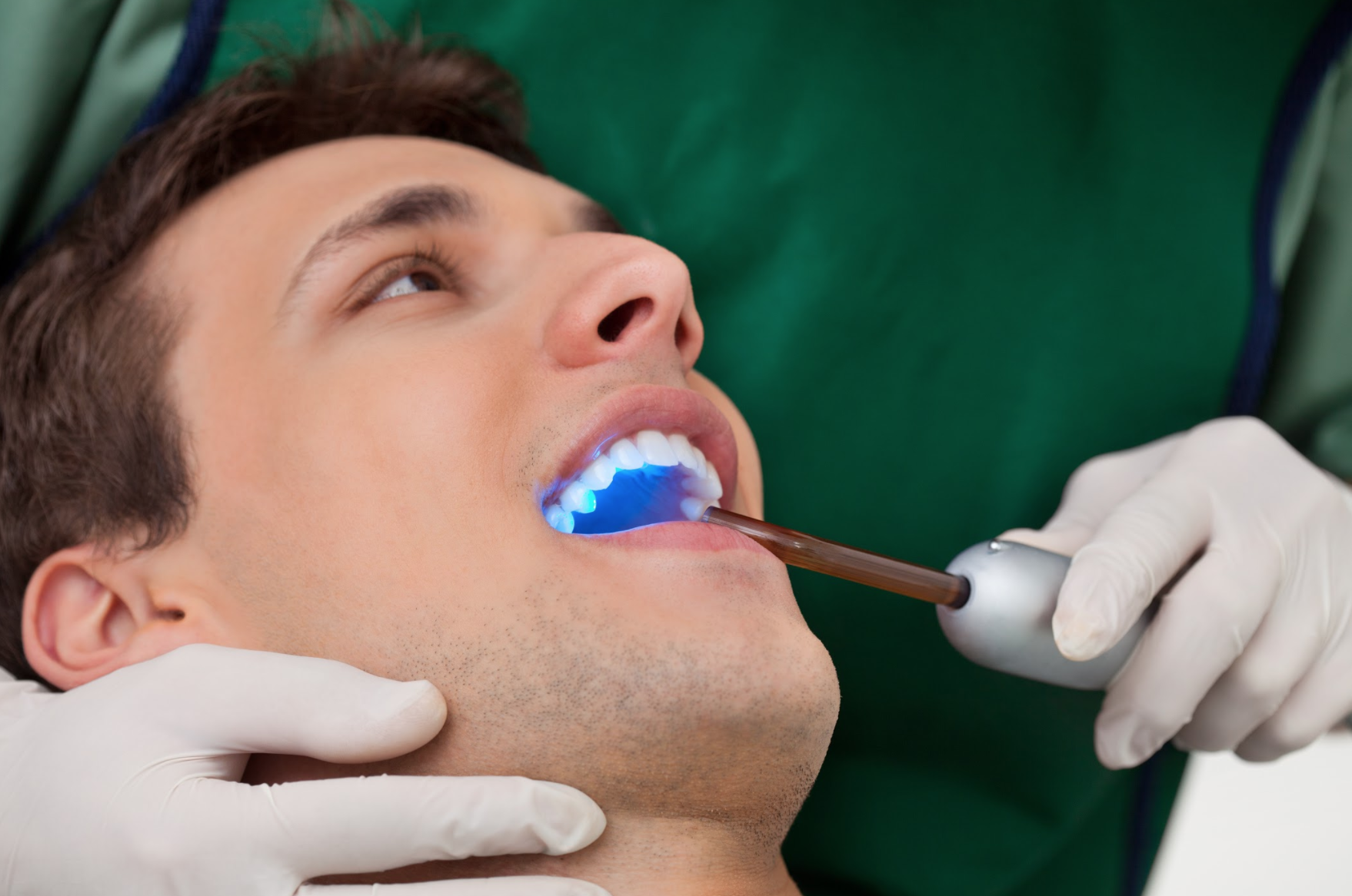 patient having ultraviolet light shined in mouth