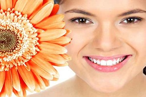 Beautiful woman smile with flower.