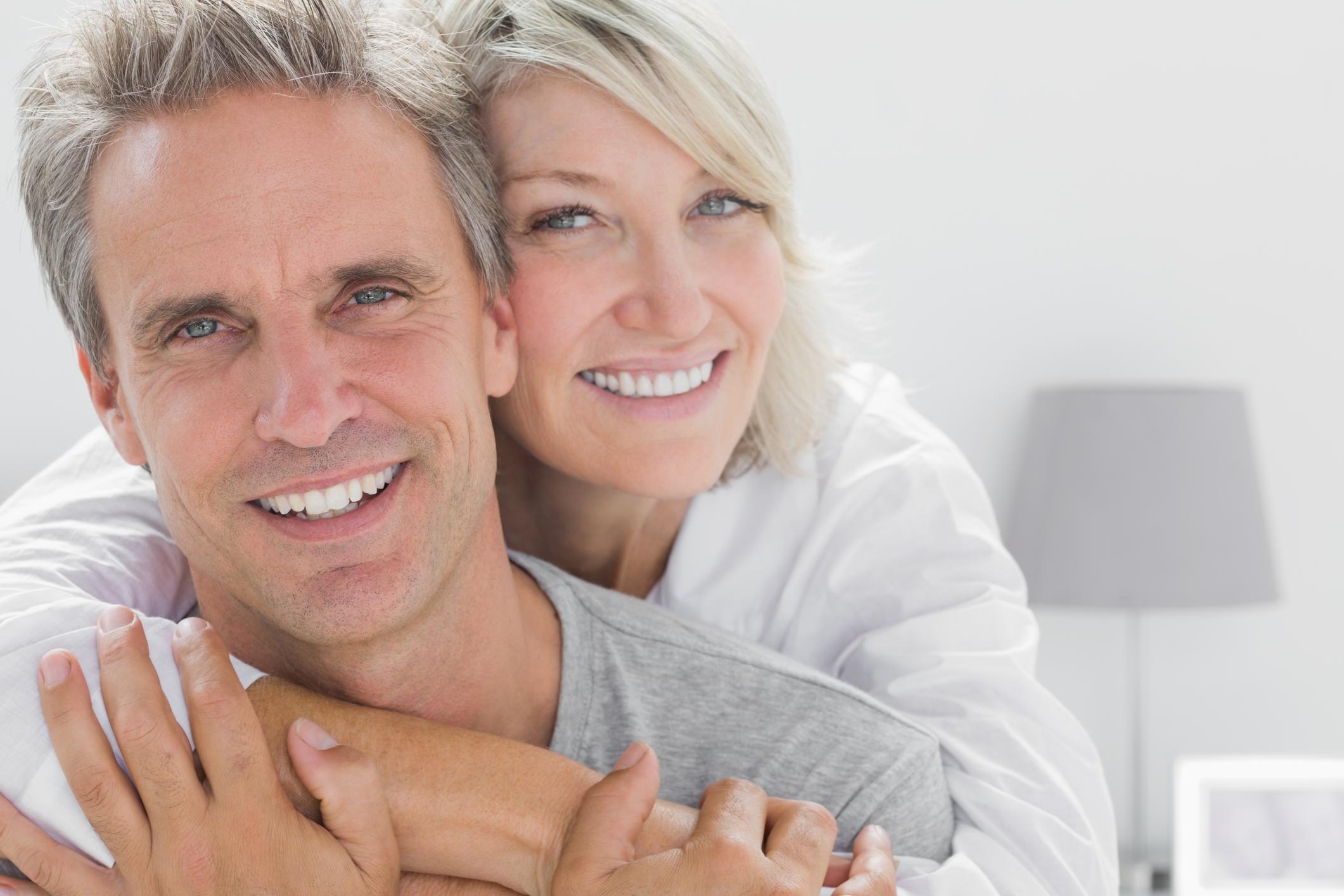 woman smiling and holding smiling man