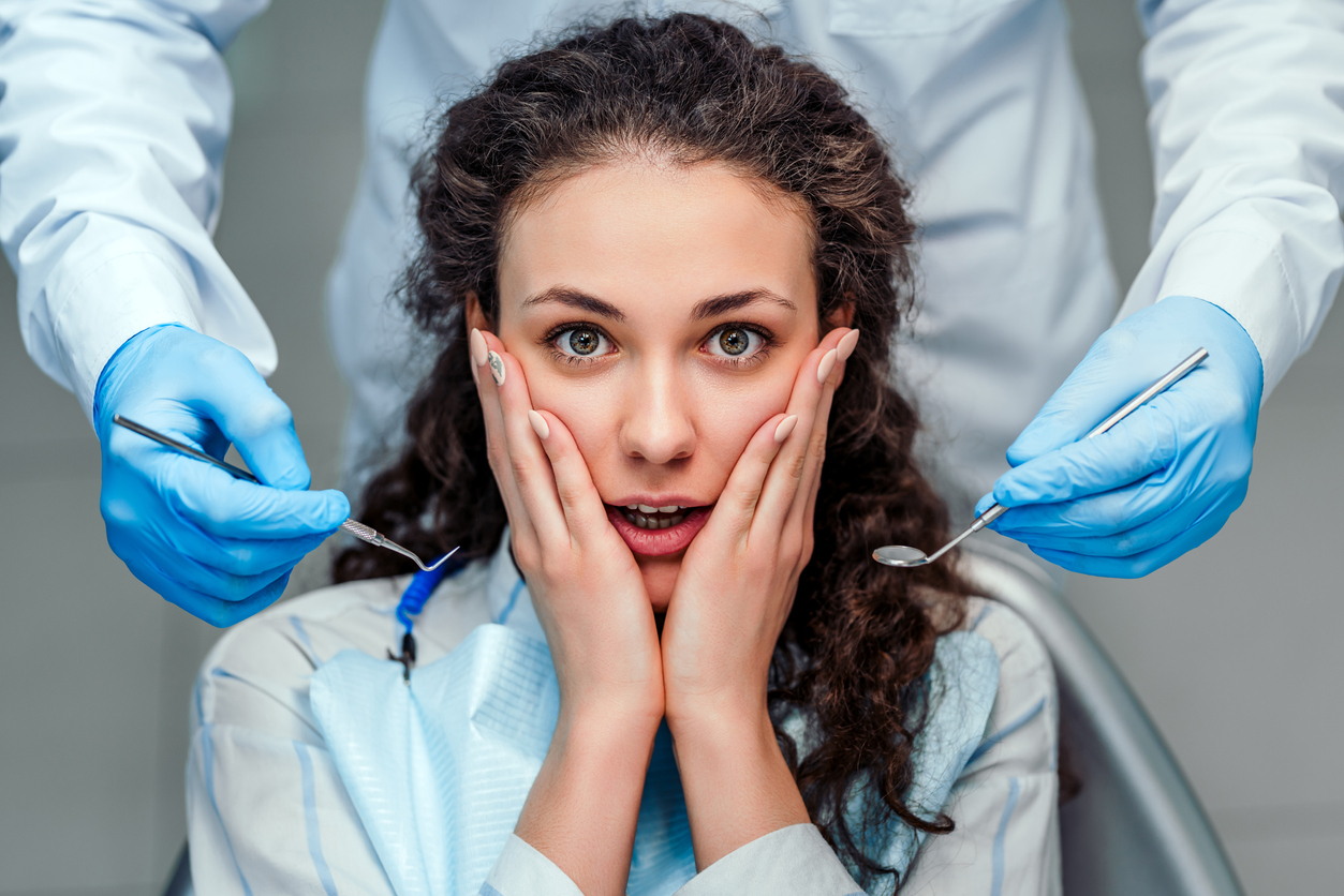 The girl is afraid of the dentist. Close up view.